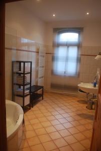 a bathroom with a sink and a toilet and a window at Ferienwohnung im Grünen - Hof Blohme in Langwedel +29 photos