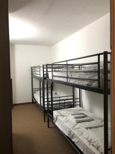 a room with three bunk beds in it at APPARTAMENTO SAN NICOLA 2 in San Massimo