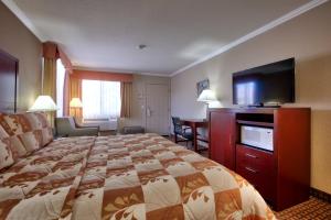 a hotel room with a bed and a flat screen tv at The Views Inn Sedona in Sedona