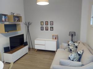 a living room with a couch and a television at Bologna House Due Torri Apartment in Bologna