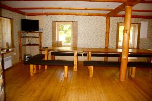 a dining room with a table and benches in a room at Kaldavere Tourism Farm in Korkuna