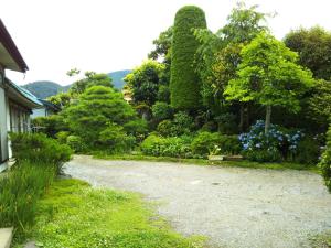 a gravel driveway in a garden with trees and bushes at Kamitakai-gun - House / Vacation STAY 12362 in Takai