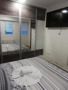 a bedroom with a bed with a towel on it at Apartman Centar 2 in Užice