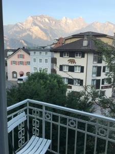 a balcony with a chair and a view of mountains at Bad Ragaz Appartement in Bad Ragaz