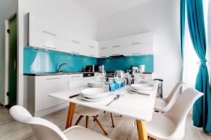 un comedor blanco con una mesa y sillas blancas en Downtown Residences, en Budapest