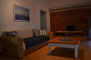 a living room with a couch and a coffee table at Apartments Golden Tüffel in Hohwacht