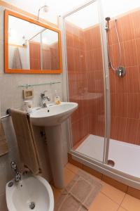 a bathroom with a sink toilet and a shower at Appartamento Palazzo Pace al Cassaro in Palermo