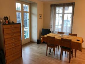 a dining room with a wooden table and chairs at Bad Ragaz Appartement in Bad Ragaz