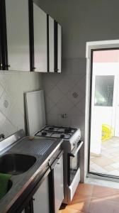 a kitchen with a sink and a stove top oven at Terrazzo 73 in Ischia