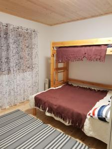 a bedroom with a wooden bed with a canopy at Järvitalo in Soini
