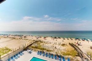 an aerial view of a beach with a pool and chairs at The Gulf Tower Condos in Gulf Shores