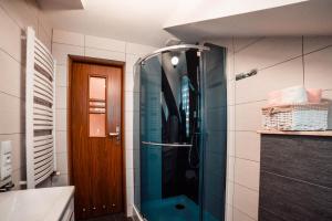 a bathroom with a shower with a glass door at Podhale Agroturystyka u Mikołajki in Długopole +27 photos