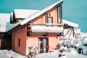 a house with snow on the roof at Podhale Agroturystyka u Mikołajki in Długopole