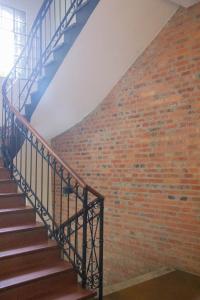 a staircase with a brick wall and blue rails at Asuncion Palace in Asuncion