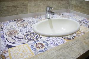 a white sink on a counter in a bathroom at Asuncion Palace in Asunción