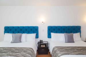 Ένα ή περισσότερα κρεβάτια σε δωμάτιο στο Hotel Varuna