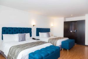 Ένα ή περισσότερα κρεβάτια σε δωμάτιο στο Hotel Varuna