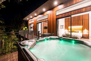 a hot tub on the balcony of a hotel room at Rainforest Retreat in Franz Josef