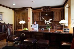 a man sitting at a bar in a room at Hotel Wolne Miasto Old Town Gdańsk in Gdańsk