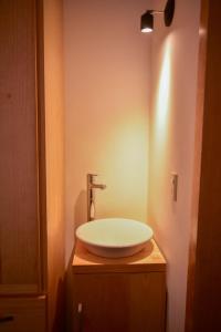 a bathroom with a white sink on a counter at HOTEL CASA SANTO TOMAS in Oaxaca City