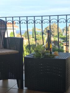 eine Flasche Wein auf dem Tisch auf dem Balkon in der Unterkunft B&B Villa Tancau in Santa Maria Navarrese