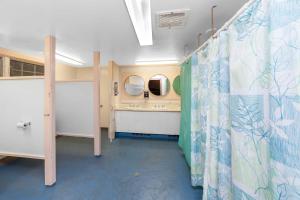 a bathroom with a shower curtain and a sink at HI - Martha's Vineyard Hostel in Vineyard Haven