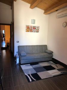 a living room with a couch and a rug at Green Orange Catania Ognina in Catania