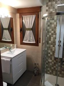 a bathroom with a sink and a shower at El Amanecer de la Sierra in Casla