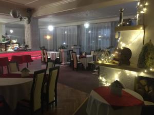 a dining room with tables and chairs and a restaurant at Hotel Mis in Bochnia