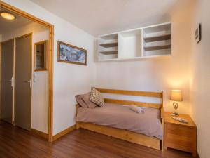 a small bedroom with a bed and a table at 26 Praz de l'Ours Vallandry - Paradiski in Peisey-Nancroix