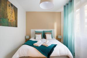 a bedroom with a bed with two towels on it at Le Belpierre in Colmar