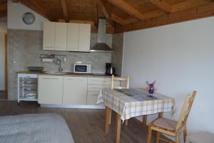 a kitchen with a table and chairs in a room at Three oranges in Trsteno