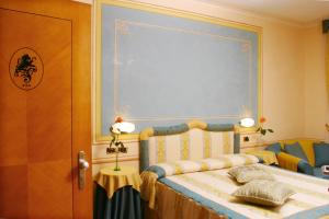 a bedroom with a bed with a large window at Hotel Leon D'Oro in Orta San Giulio
