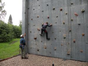two men are climbing on a climbing wall at Johannisholm Adventure in Johannisholm