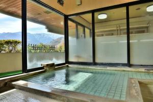 a swimming pool with a view of the mountains at Hosonokan in Hakuba