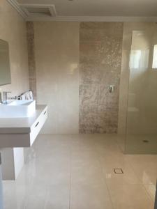 a bathroom with a sink and a shower at Kindred Studio Apartments in Leeton