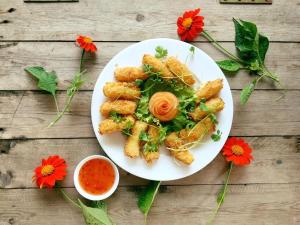 a plate of food with a salad and sauce at Thanh Dat Resort in Can Tho