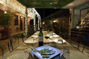 a table with a bottle of wine and a plate of food at Gwandalan House in Dipolog