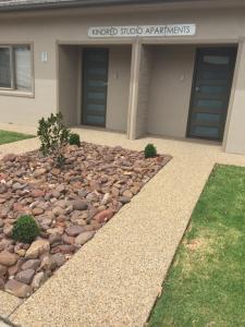 a building with a pile of rocks in front of it at Kindred Studio Apartments in Leeton