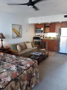 a living room with a bed a couch and a kitchen at Deluxe Oceanview Maui Studio..New & Updated in Kahana