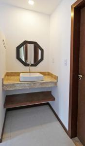 a bathroom with a sink and a mirror at Casa Marilù in Morro de São Paulo