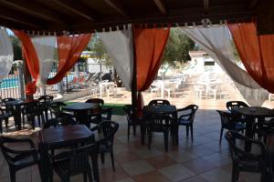 een restaurant met tafels en stoelen en een patio bij Funno Delle Noci in Peschici