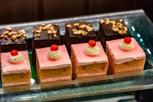 a bunch of pink frosted cakes with cherries on top at Viangluang Resort in Chiang Mai