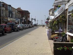 a street with cars parked on the side of the road at The Strathdon in Blackpool