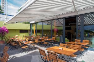 a group of tables and chairs in front of a building at Best Western Hotel Spirgarten in Zurich