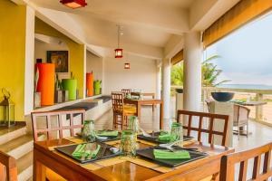 a kitchen with a table and chairs and a large window at Jetwing Sea in Negombo