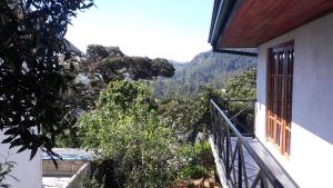 a balcony of a house with a view of a mountain at B&B Nuwara eliya in Nuwara Eliya