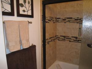 a bathroom with a shower and a tub and a toilet at Sierra Manor in Mammoth Lakes