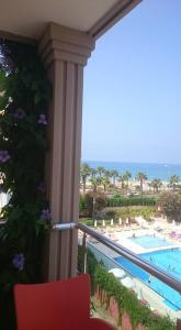 a room with a balcony with a view of the pool at Anik Apart Hotel in Alanya