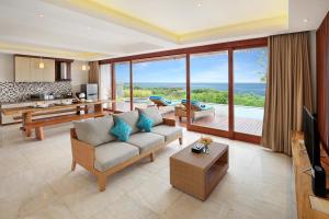 a living room with a couch and a television at Ocean View Villa Hotman Paris VII in Jimbaran